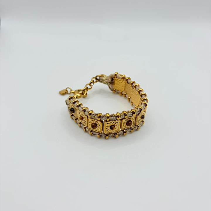 Habaha gold bohemian bracelet with textured metal details, woven cord and natural stone accents