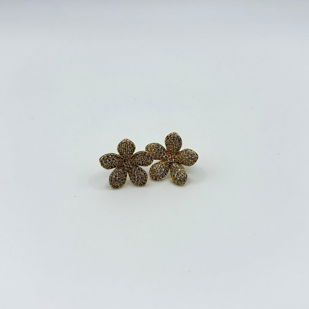 Habaha gold flower stud earrings with sparkling pavé crystals and floral design on a white background