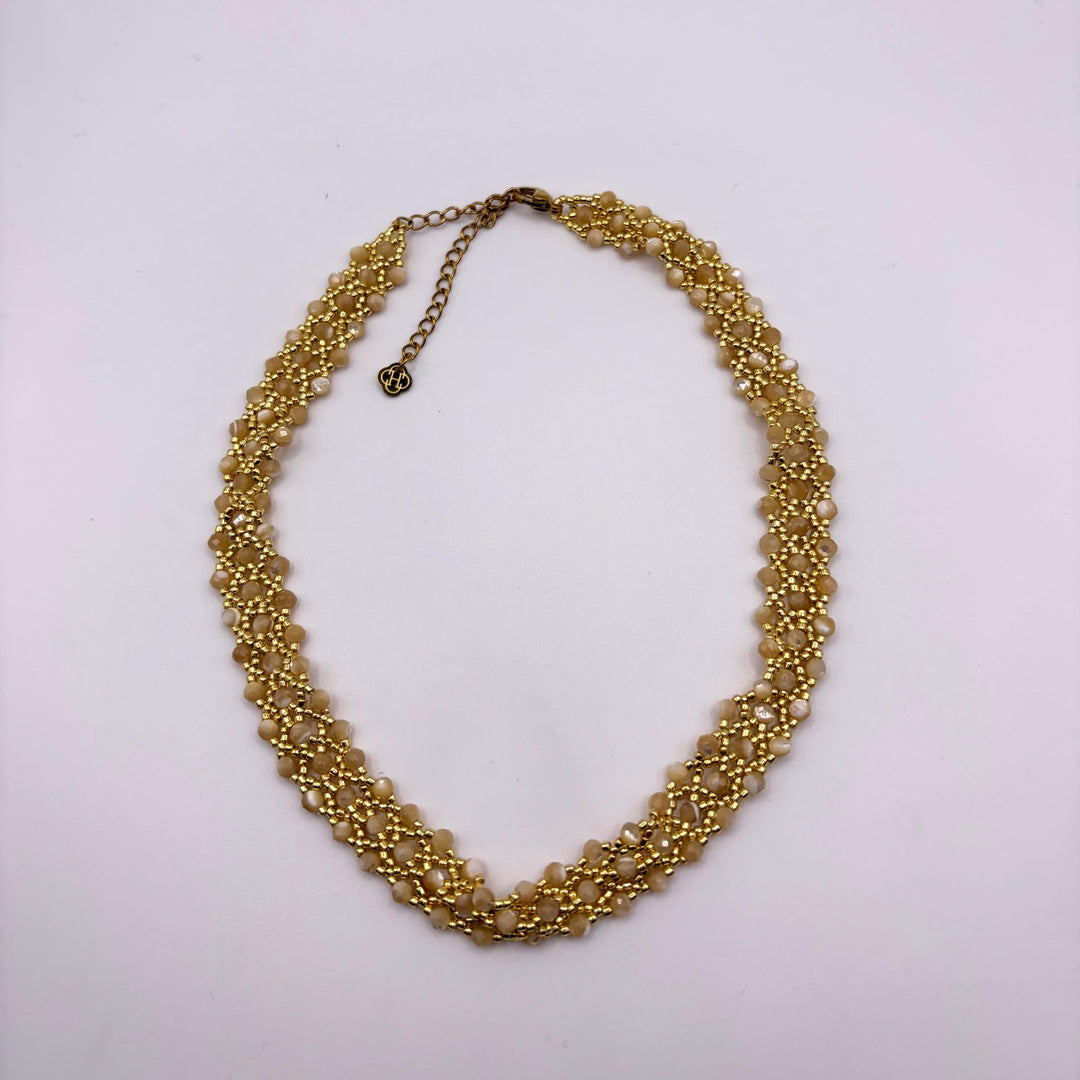Habaha Nayara Luz short natural stone necklace with beige stones and intricate gold beadwork.