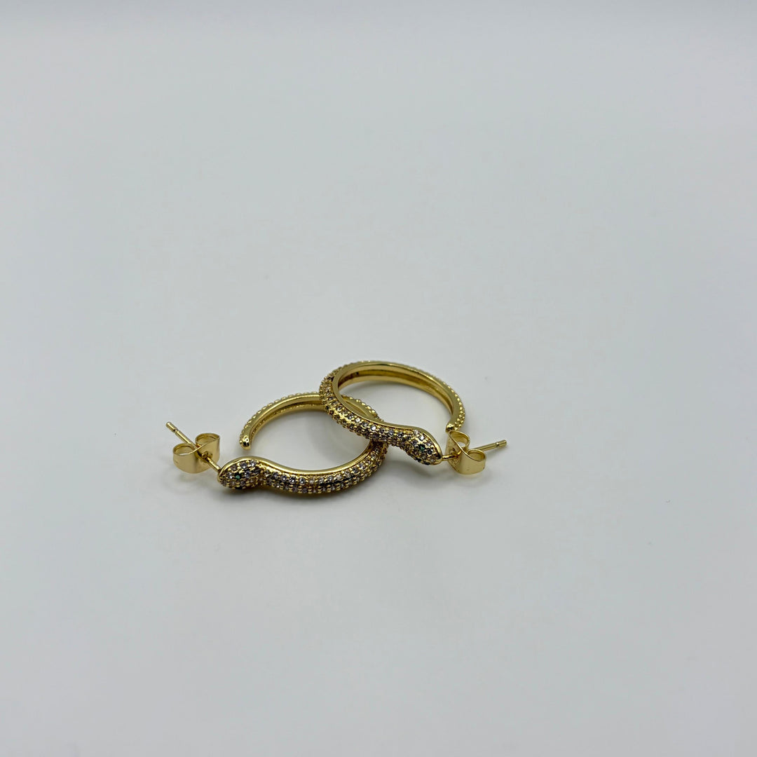 Habaha gold snake hoop earrings with pavé crystal detailing and elegant serpent design on a white background