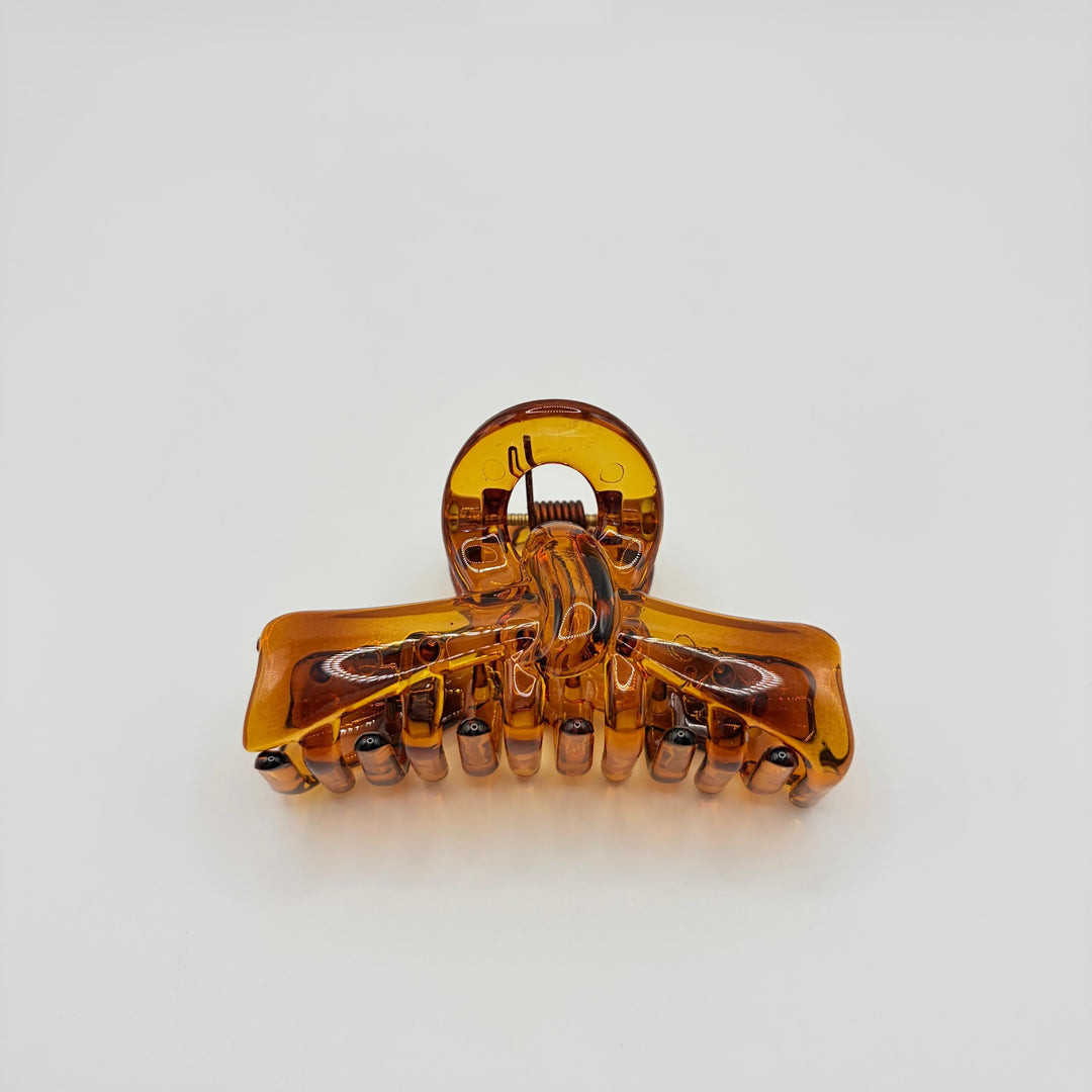 Miel amber hair claw by Beebop with translucent honey finish, curved teeth and classic spring design