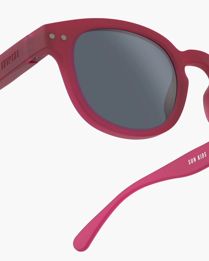 IZIPIZI CHILD #C Cranberry polarized kids sunglasses with shiny pink frame, grey-green lenses and 100% UV protection