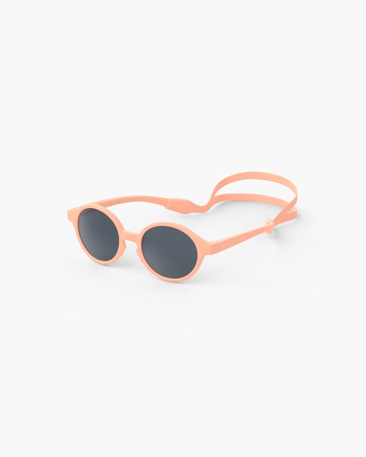 IZIPIZI Baby #D Apricot polarized sunglasses for toddlers aged 0–3 with a soft peach matte frame and grey lenses