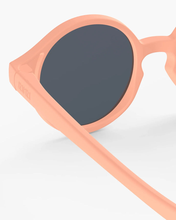 IZIPIZI Baby #D Apricot polarized sunglasses for toddlers aged 0–3 with a soft peach matte frame and grey lenses