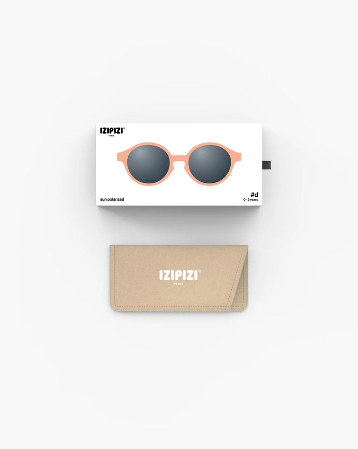 IZIPIZI Baby #D Apricot polarized sunglasses for toddlers aged 0–3 with a soft peach matte frame and grey lenses
