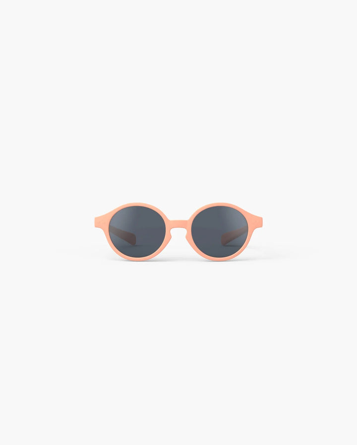 IZIPIZI Baby #D Apricot polarized sunglasses for toddlers aged 0–3 with a soft peach matte frame and grey lenses