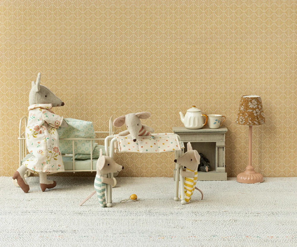 Maileg off-white nursery table for baby mouse with fabric side pockets, miniature rattle and baby lotion