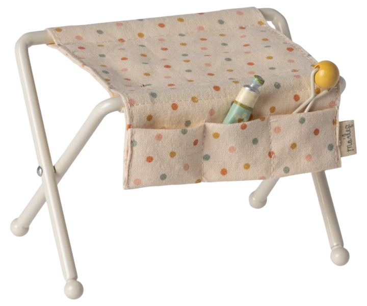 Maileg off-white nursery table for baby mouse with fabric side pockets, miniature rattle and baby lotion