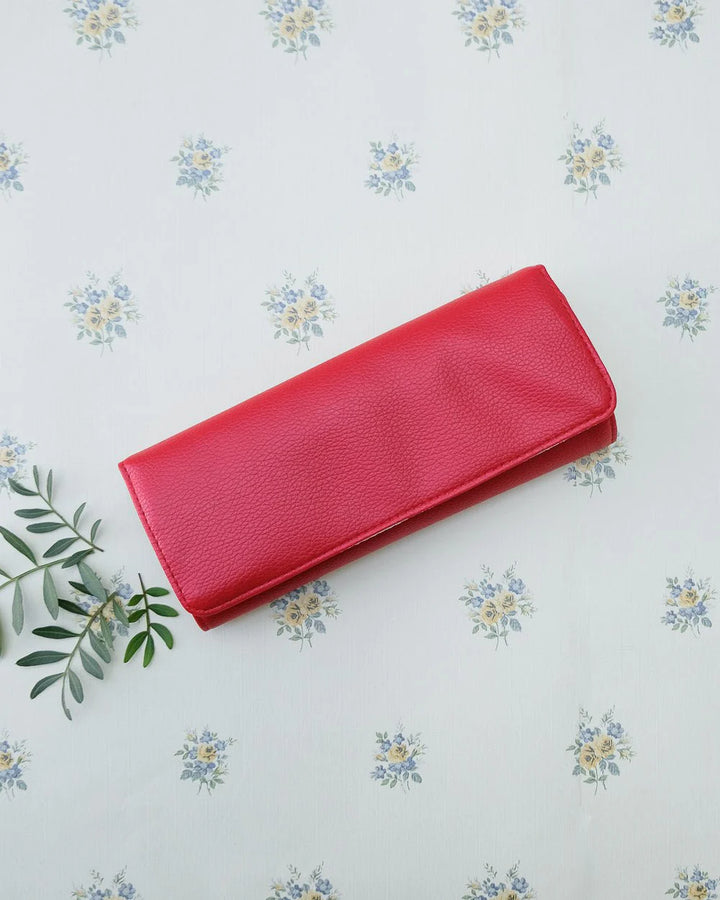 Red travel jewelry pouch with ring and earring holders by Maison Scarlett