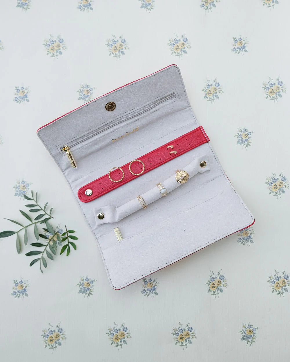 Red travel jewelry pouch with ring and earring holders by Maison Scarlett