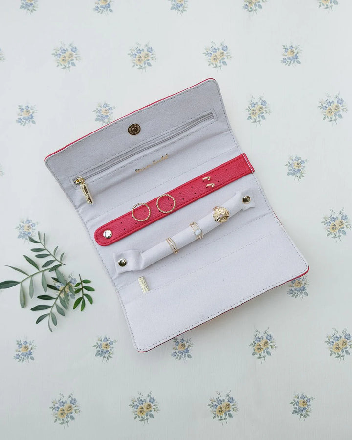 Red travel jewelry pouch with ring and earring holders by Maison Scarlett