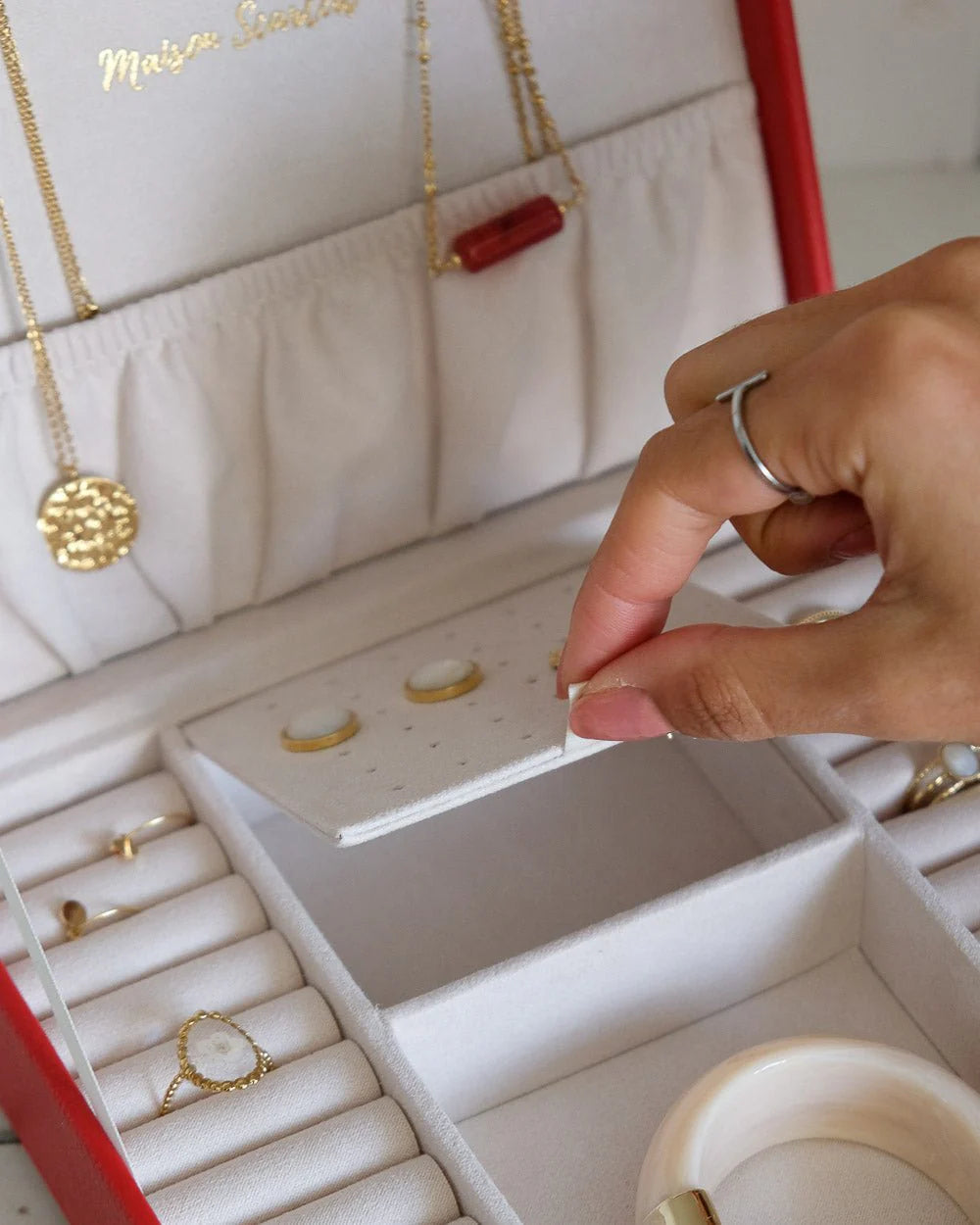 Red leather jewelry box with gold clasp by Maison Scarlett