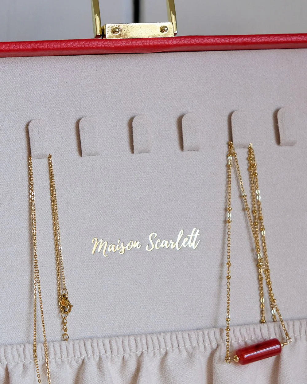 Red leather jewelry box with gold clasp by Maison Scarlett