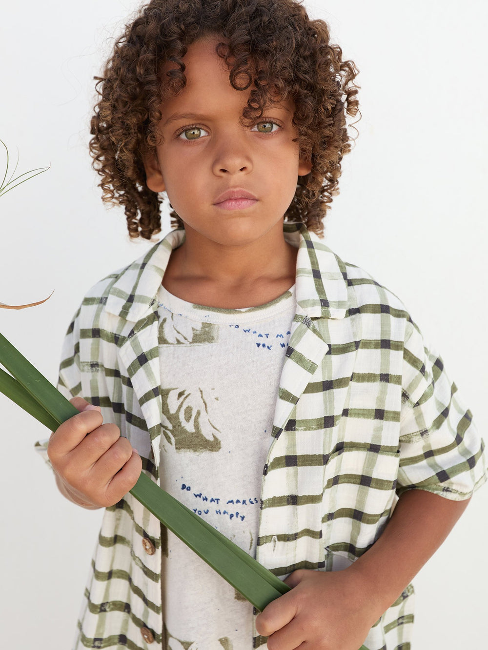 Boy wearing check organic cotton shirt with short sleeves by Play Up