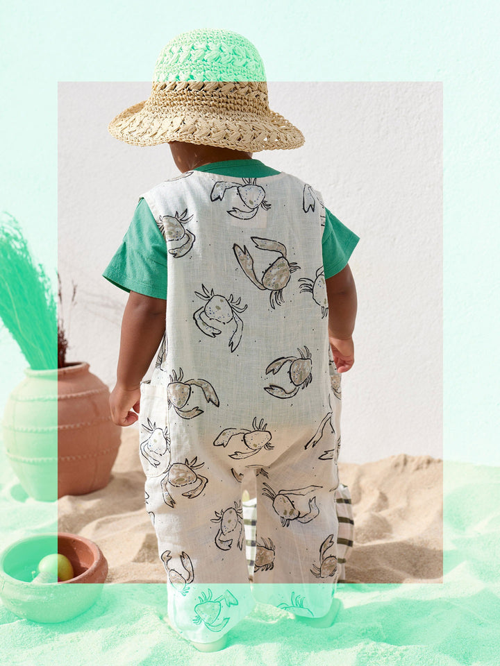 Baby linen romper with crab print and wooden buttons in soft natural tones