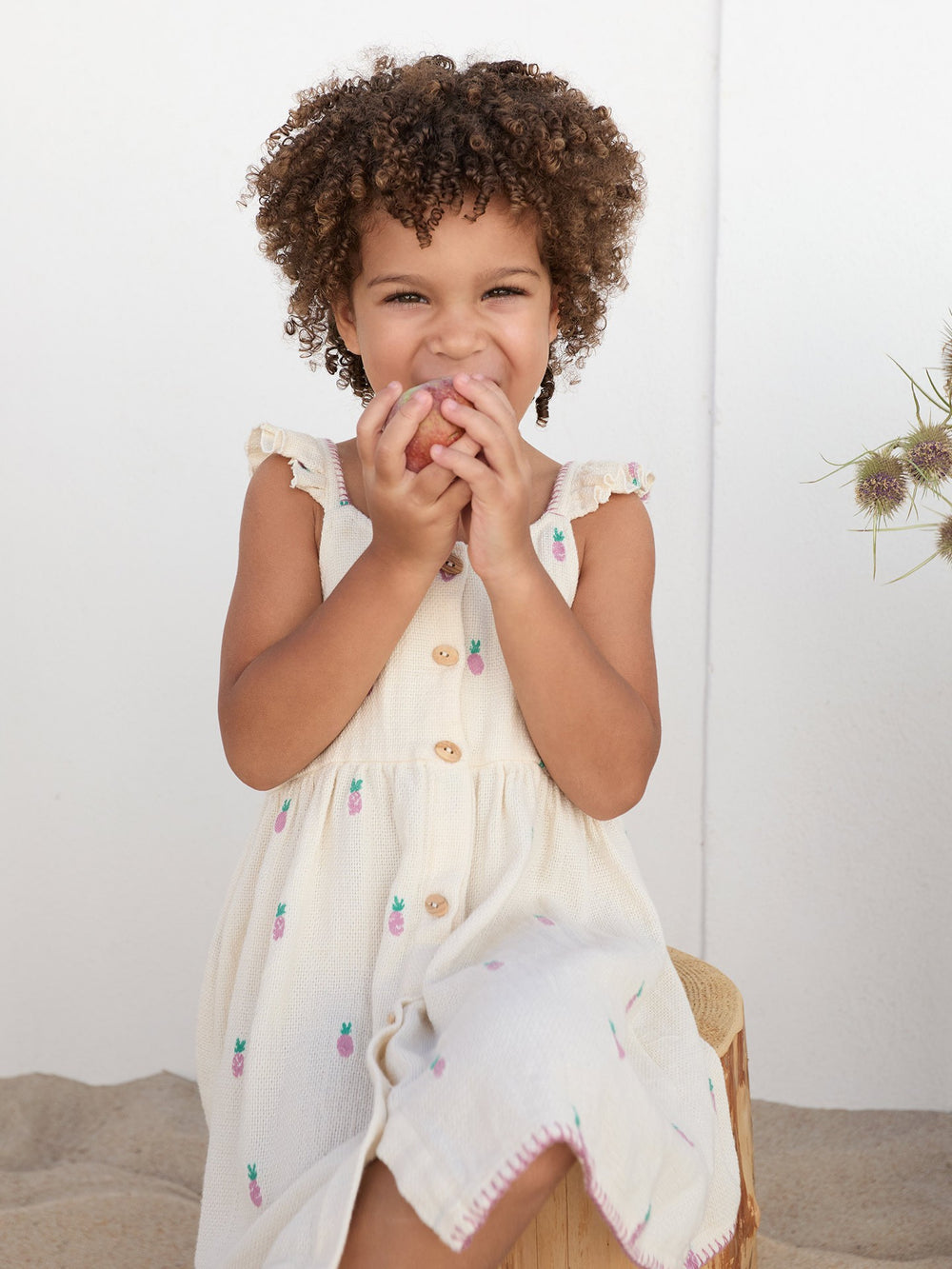 Baby girl pineapple print dress in textured cream cotton with flutter sleeves and wooden buttons