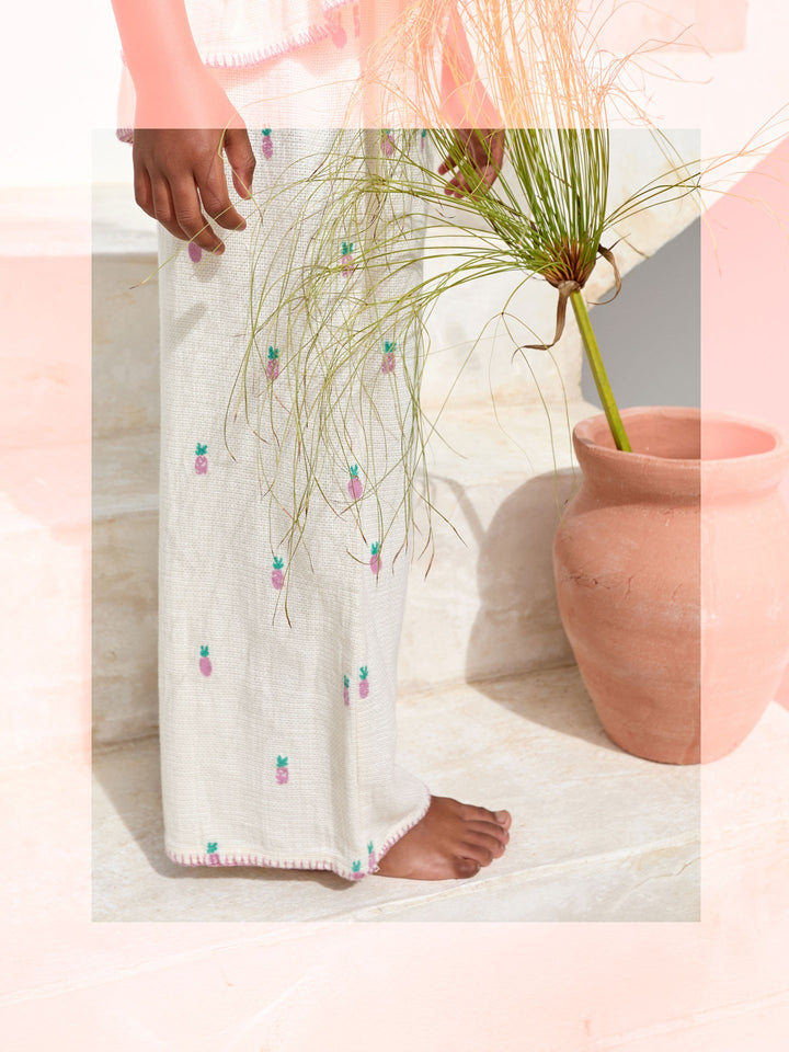 Girls cream textured trousers with pink pineapple print and elastic waistband