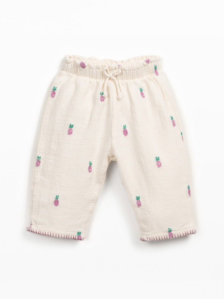 Girls cream textured trousers with pink pineapple print and elastic waistband
