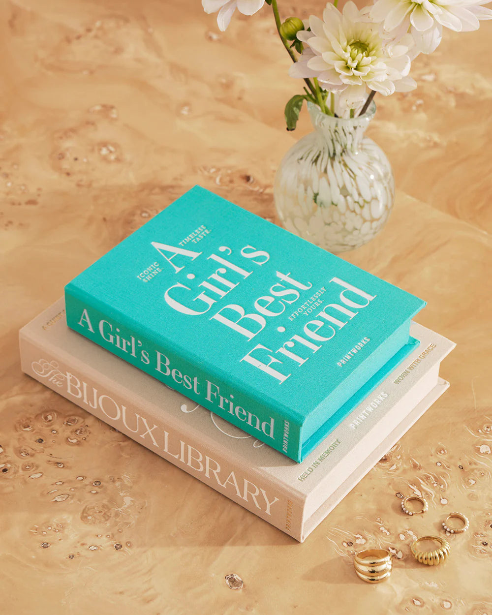 Turquoise jewellery box with book-inspired design and organised compartments for rings, necklaces and earrings