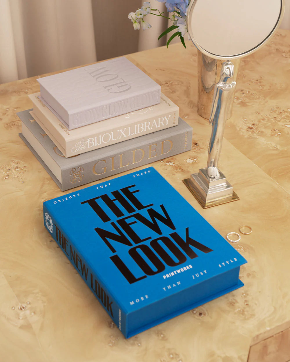Blue jewellery box with book-inspired design and organised compartments for rings, earrings and necklaces