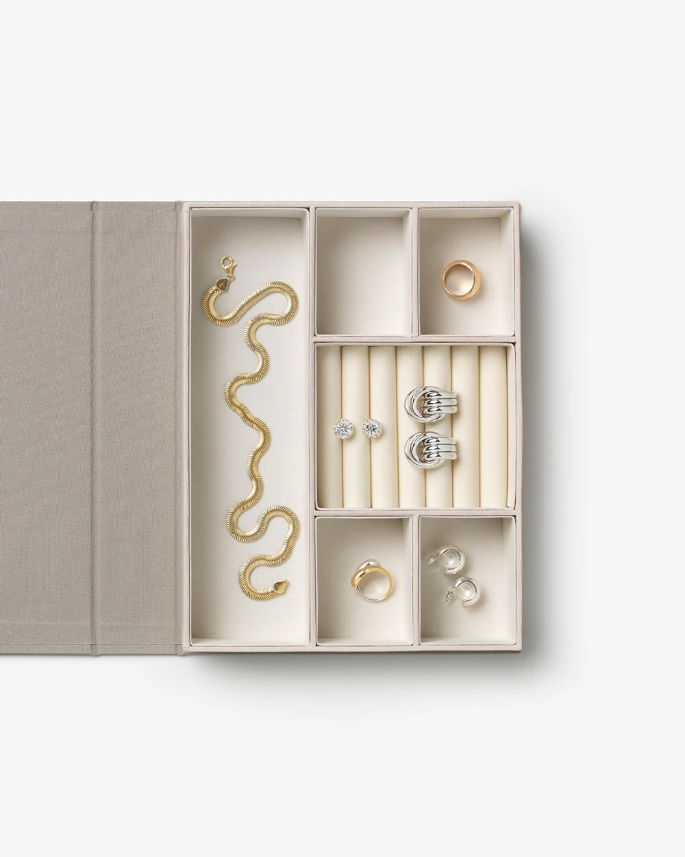Gilded jewelry box with taupe linen cover, gold lettering and velvet-lined compartments for elegant jewellery storage