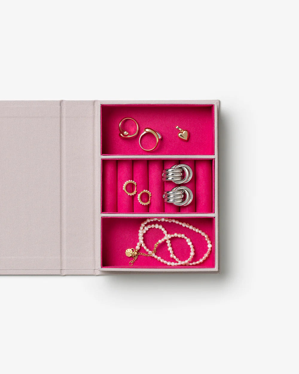 Glow jewellery box with soft pink velvet-lined compartments and elegant book-inspired storage design