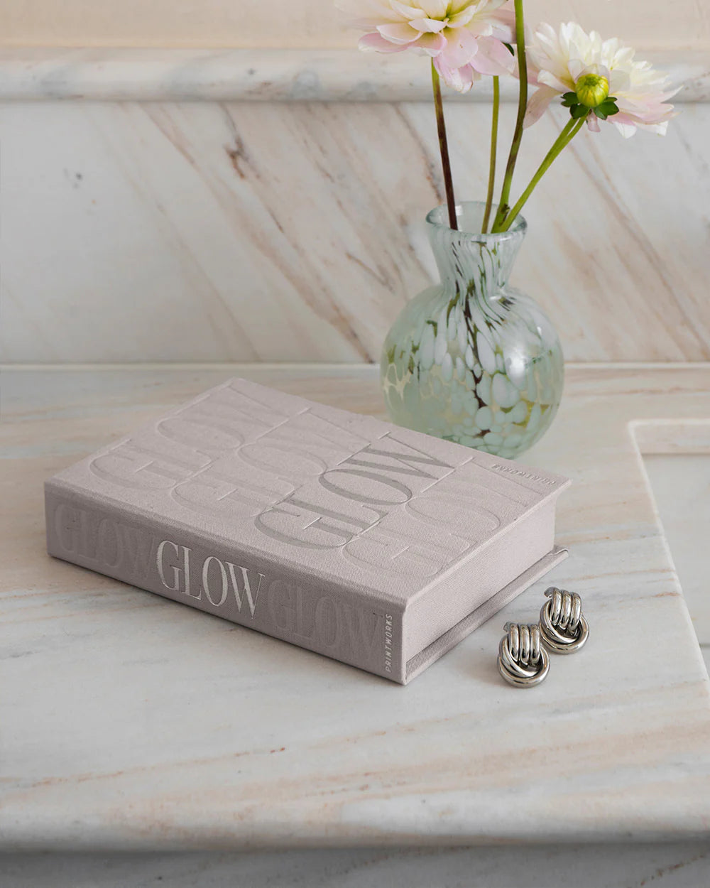 Glow jewellery box with soft pink velvet-lined compartments and elegant book-inspired storage design