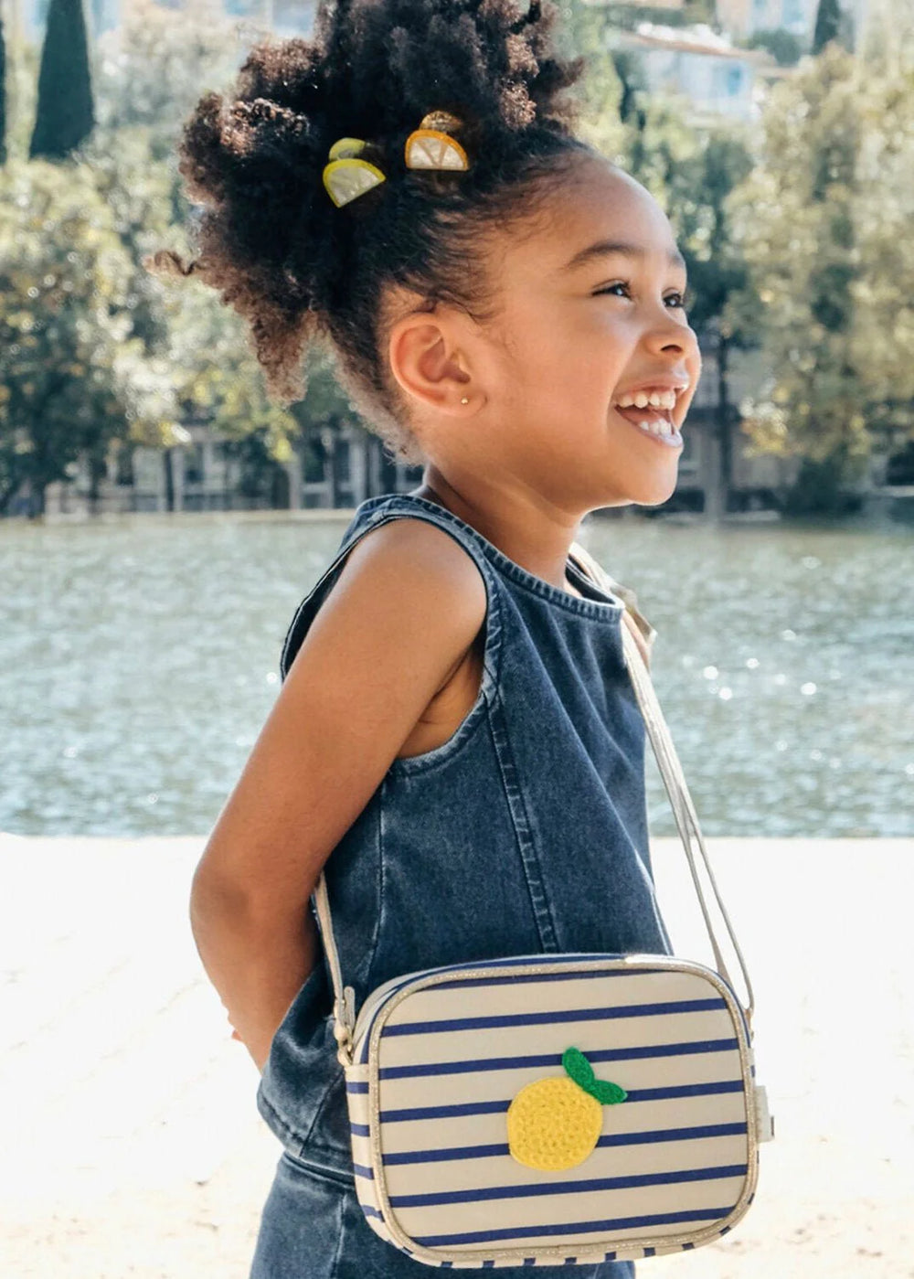 Rockahula Lemon Drop stripy kids bag with bold stripe design and zip closure on girll
