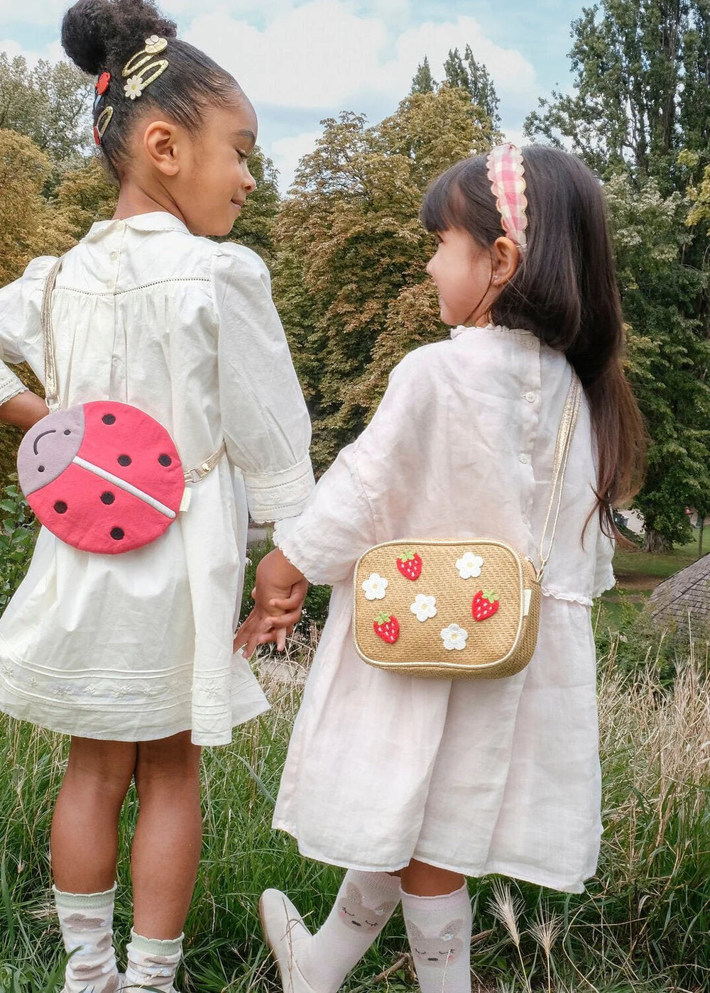 Rockahula Strawberry Fields raffia kids bag with embroidered strawberries and daisies on girl