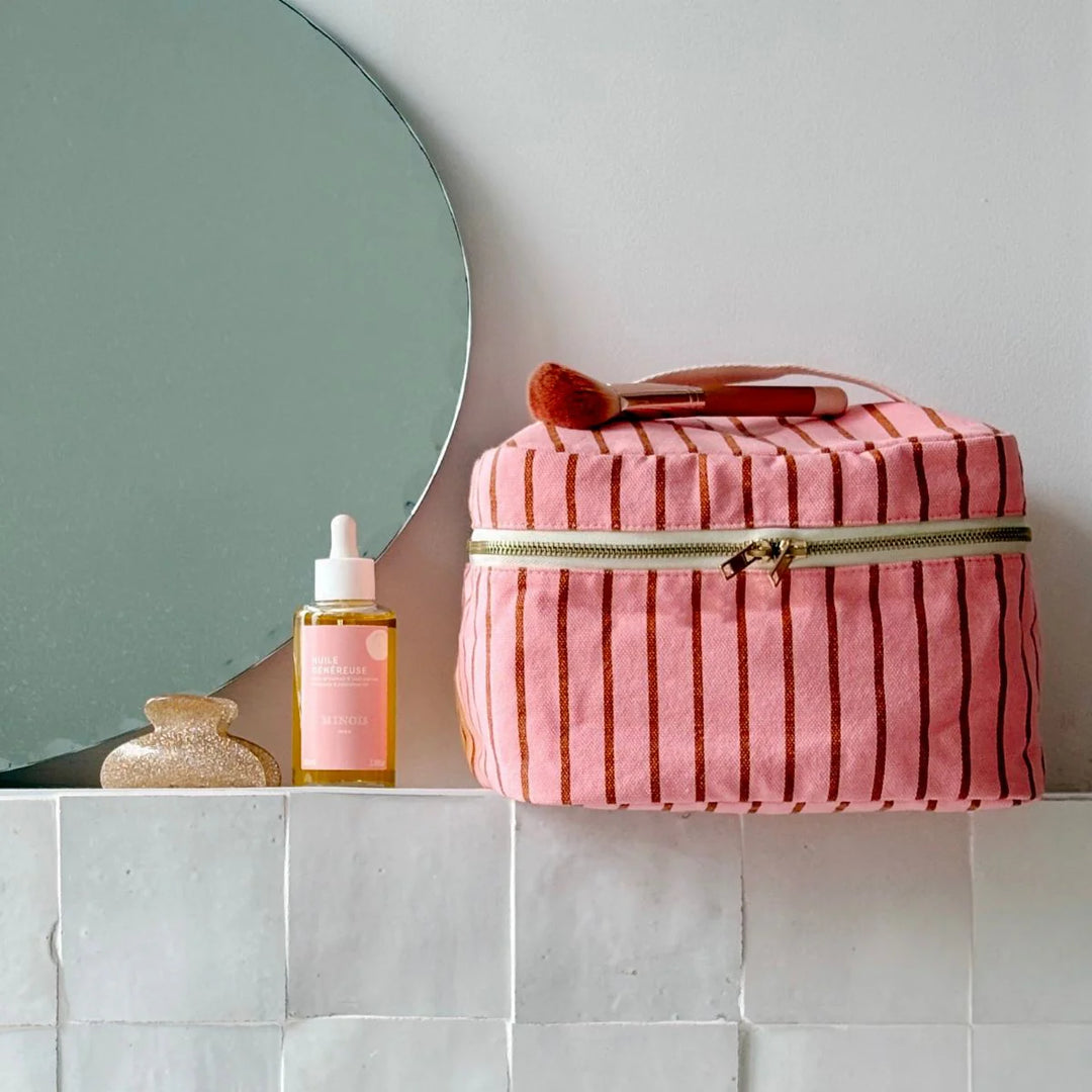 Rose in April Suki Vanity striped cosmetic case in pink and coral with zip closure.