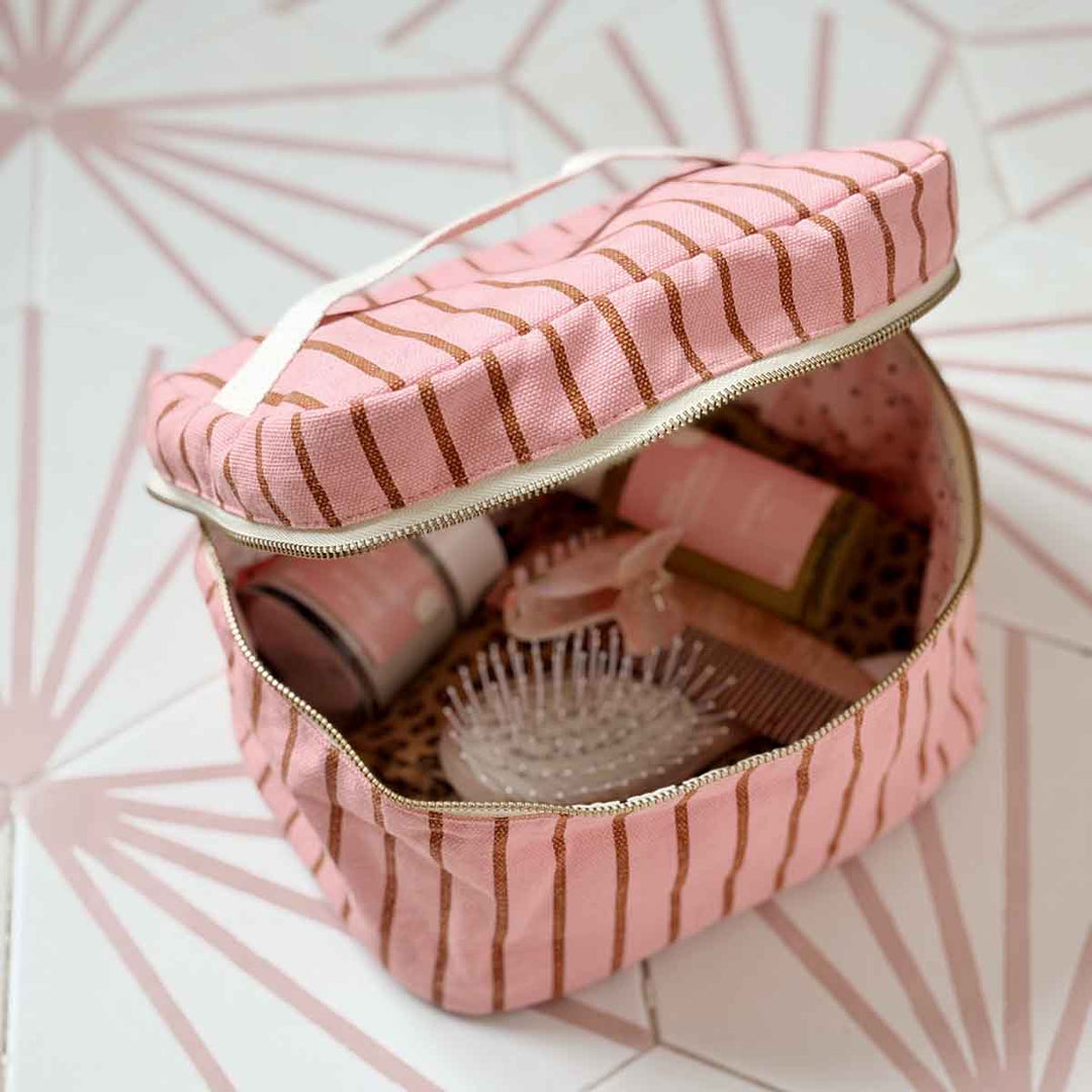 Rose in April Suki Vanity striped cosmetic case in pink and coral with zip closure.